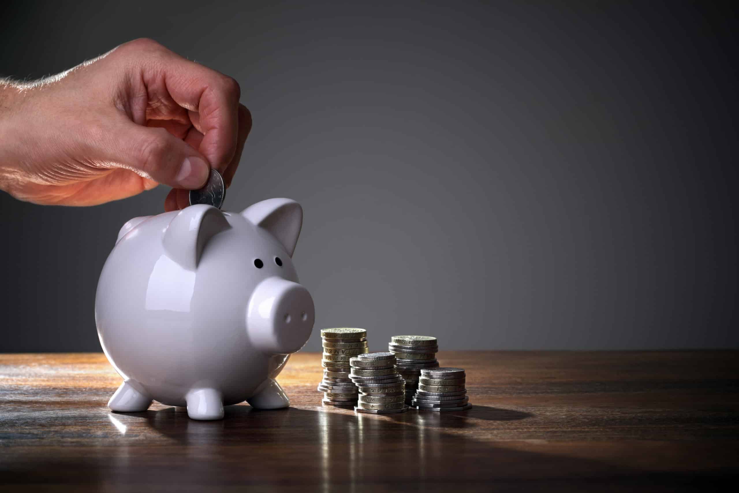 Inserting a coin into a piggy bank